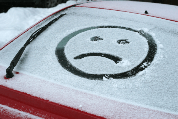 Frowny face drawn
in snow on windshield