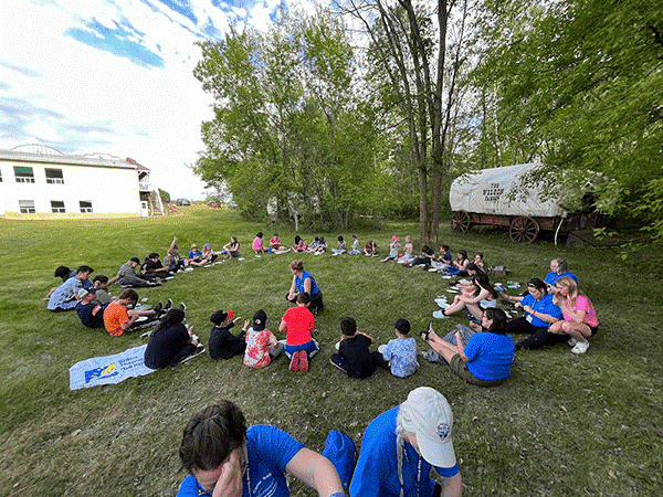 Children sitting in a circle on grass