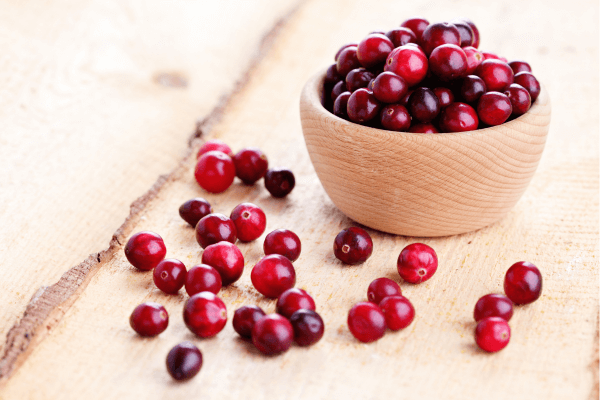 Cranberries in a wooden bowl.