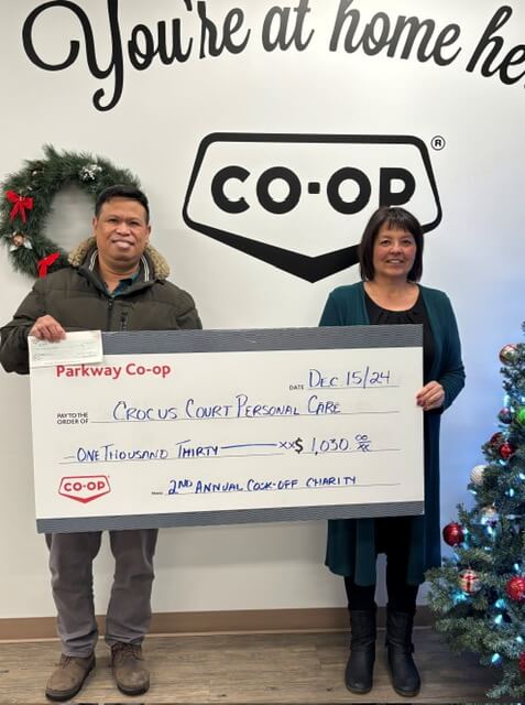 Jesus Dangat, Manager Health Services - LTC, Crocus Court PCH accepts cheque from Michelle Neepin, Office Clerk, Parkway Consumers Co-op