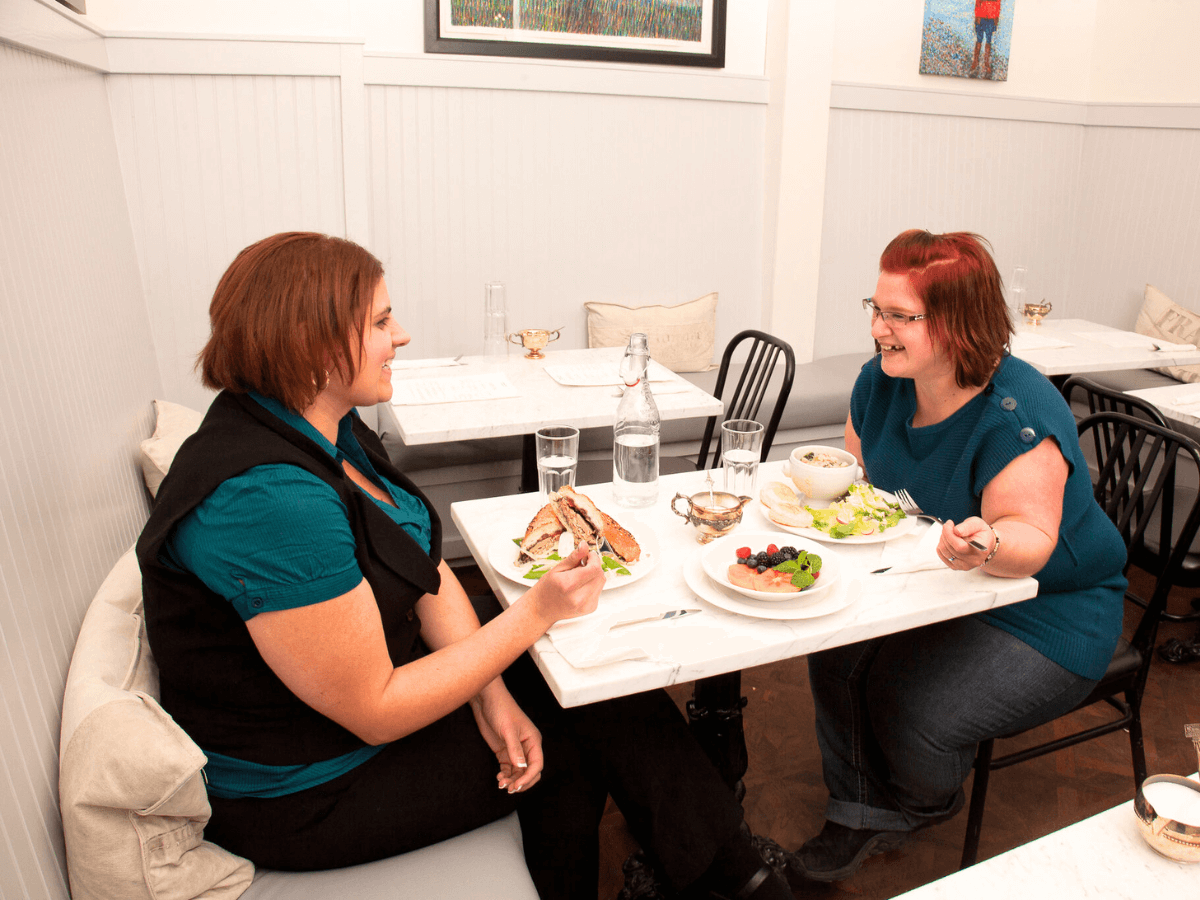 two ladies eating lunch in a restaurant