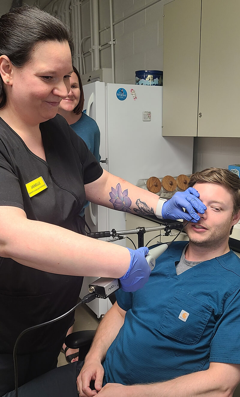 Janelle Lamontagne, fellow SLP, inserting a nasoendoscope into Jordan Hagemeister’s nose during a training session.