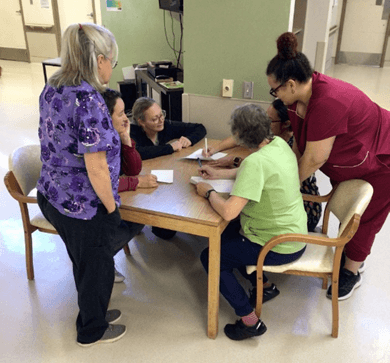 Staff working on a project around a table.