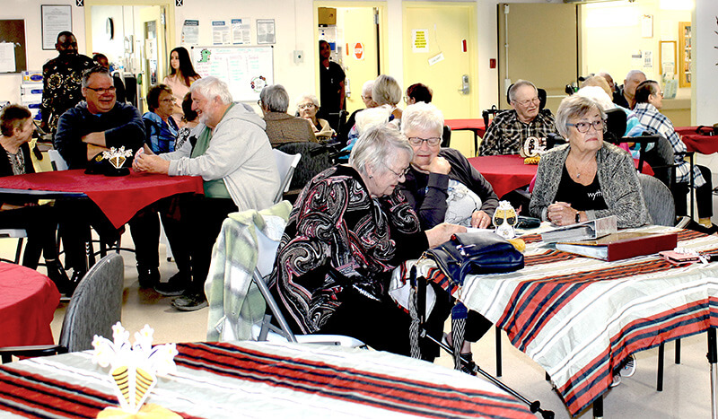 Attendees at the Grandview PCH 50th Anniversary May 6 look through photo albums and share memories following the recognition event.