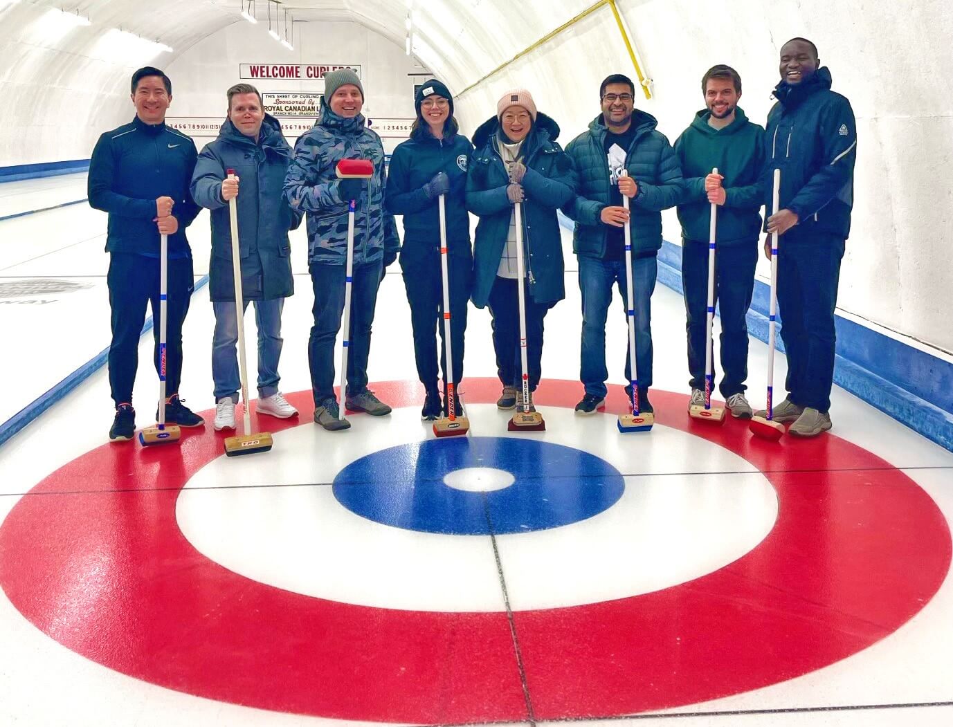 Medical Residents visiting Grandview stand on the curling ice.
