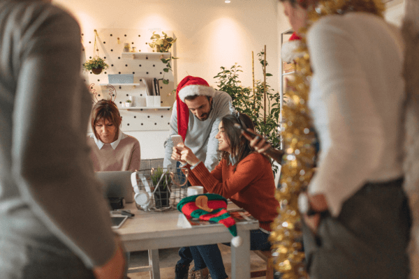 grownups busy on phones and laptops at Christmas time.