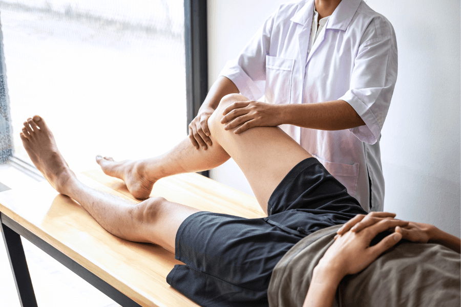 Physiotherapist working on a man's leg.