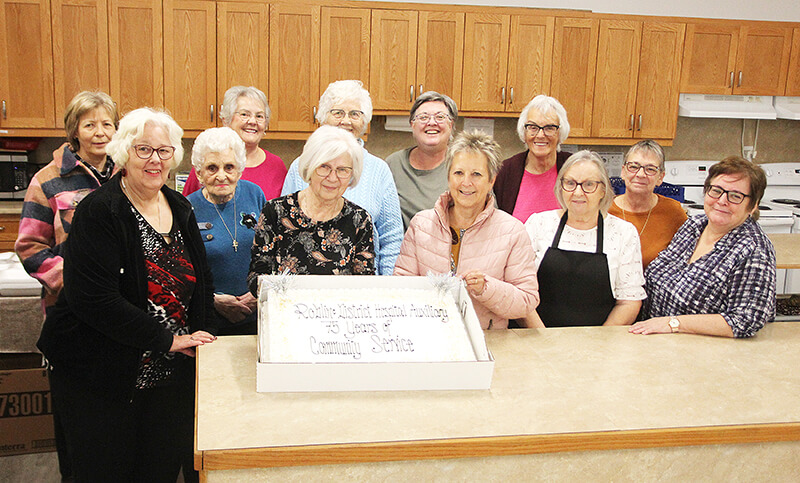 Members of Roblin Health Care Auxiliary with cake.