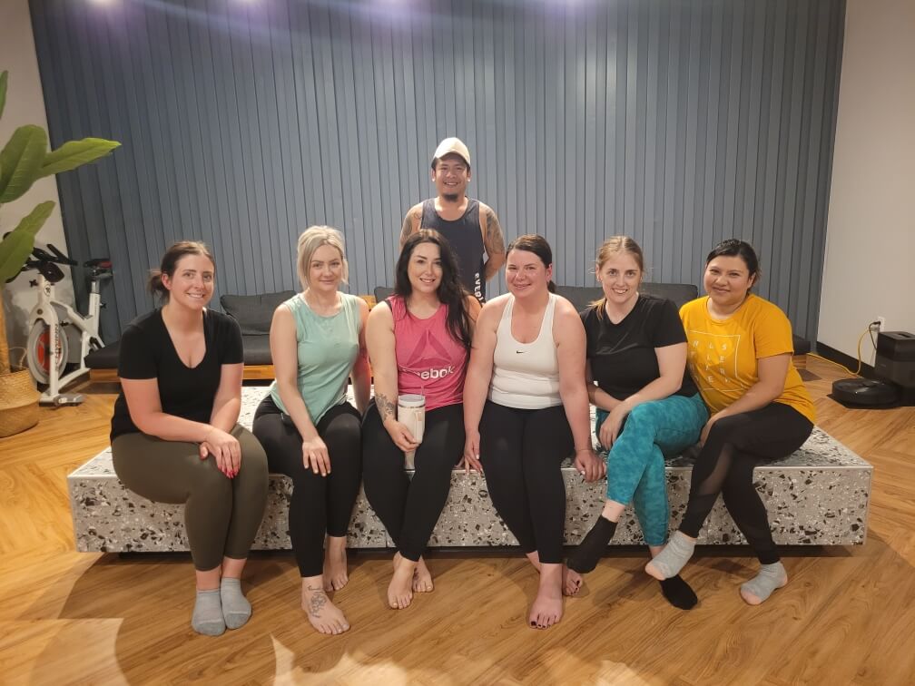 people sitting on a couch in workout clothes